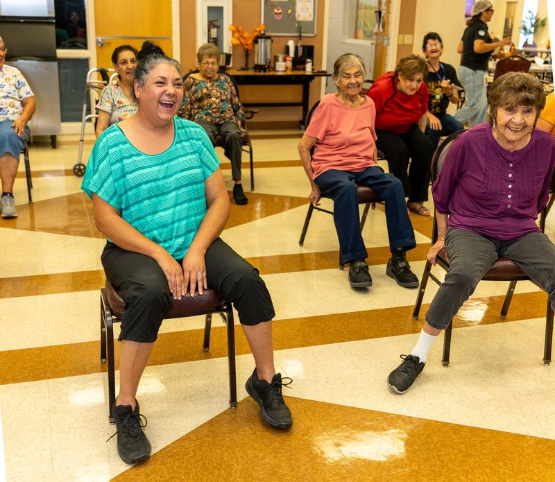 A participant laughs as the class moves together.